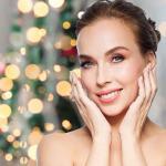 Woman smiling with Christmas tree behind