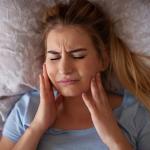 Woman in pain with bruxism